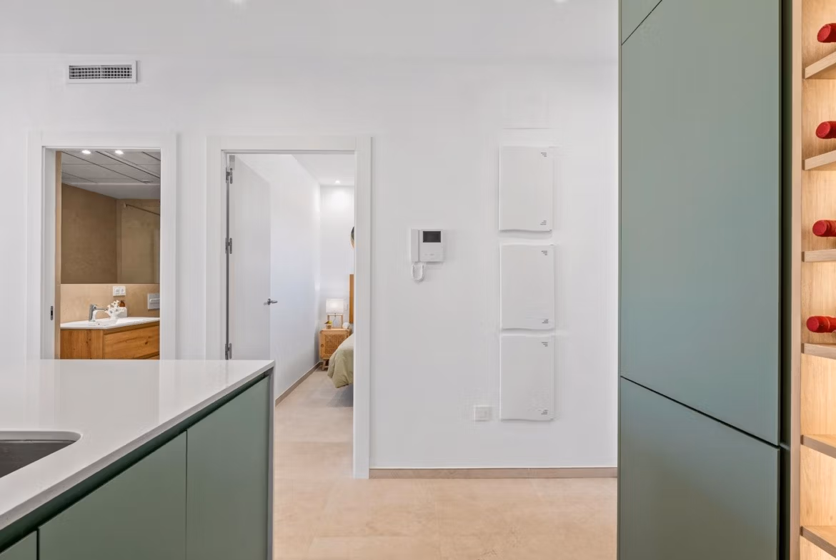 Bright modern kitchen and hallway with sleek cabinetry in a 2-bedroom ground floor apartment in Serena Golf, Los Alcazares
