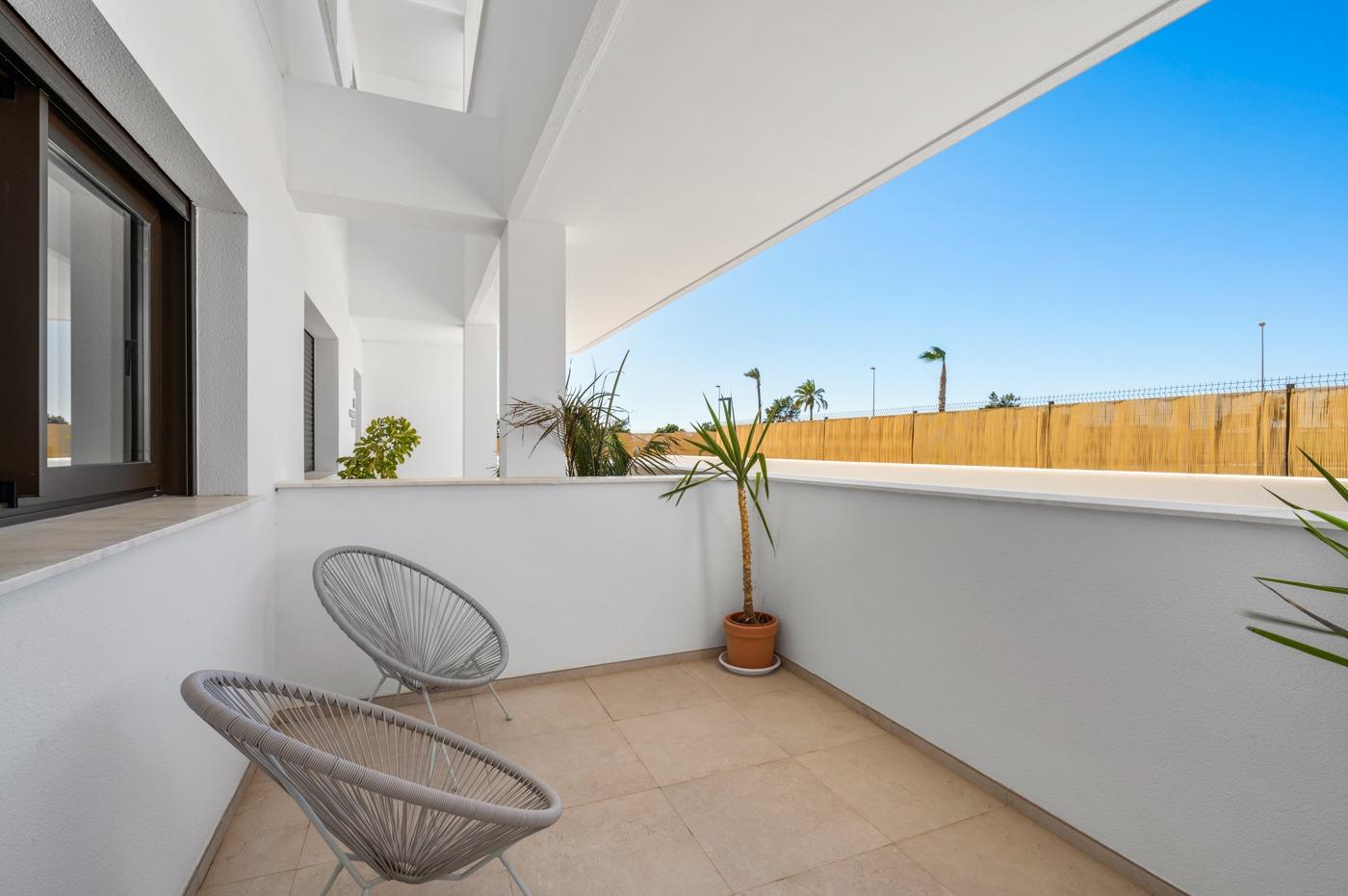 Bright, spacious terrace with modern seating in a luxury 2-bedroom first floor apartment at Serena Golf, Los Alcazares