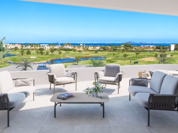 Sun-drenched terrace with elegant outdoor seating overlooking the lush golf course and sea in a 2-bedroom Serena Golf apartment, Los Alcazares.