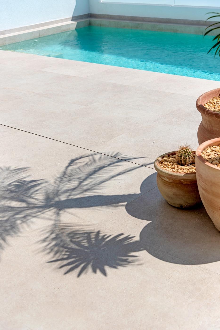 Sunlit private pool area with modern tiled terrace and decorative pots at spacious 3-bedroom semi-detached villa in Dolores, Alicante