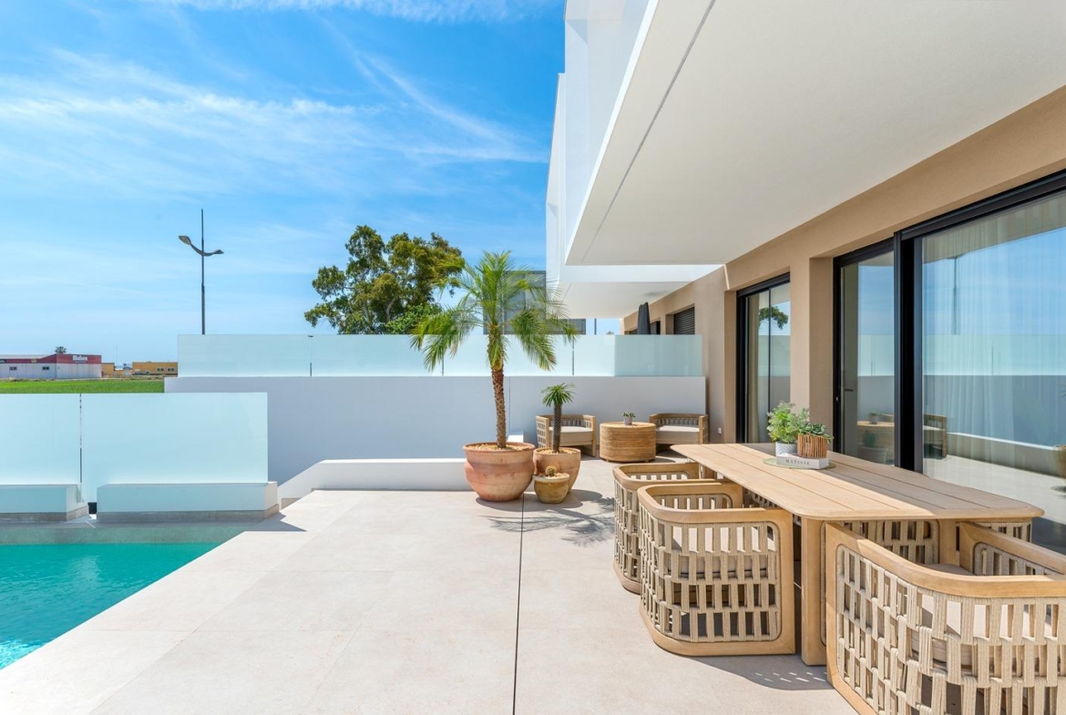 Sun-drenched terrace with modern outdoor dining and private pool at spacious new build 3-bedroom villa in Dolores, Alicante