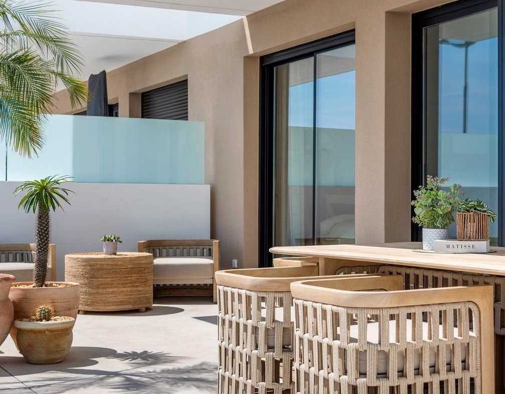 Sunlit modern terrace with stylish wicker furniture in a spacious 3-bedroom semi-detached villa, Dolores, Alicante.