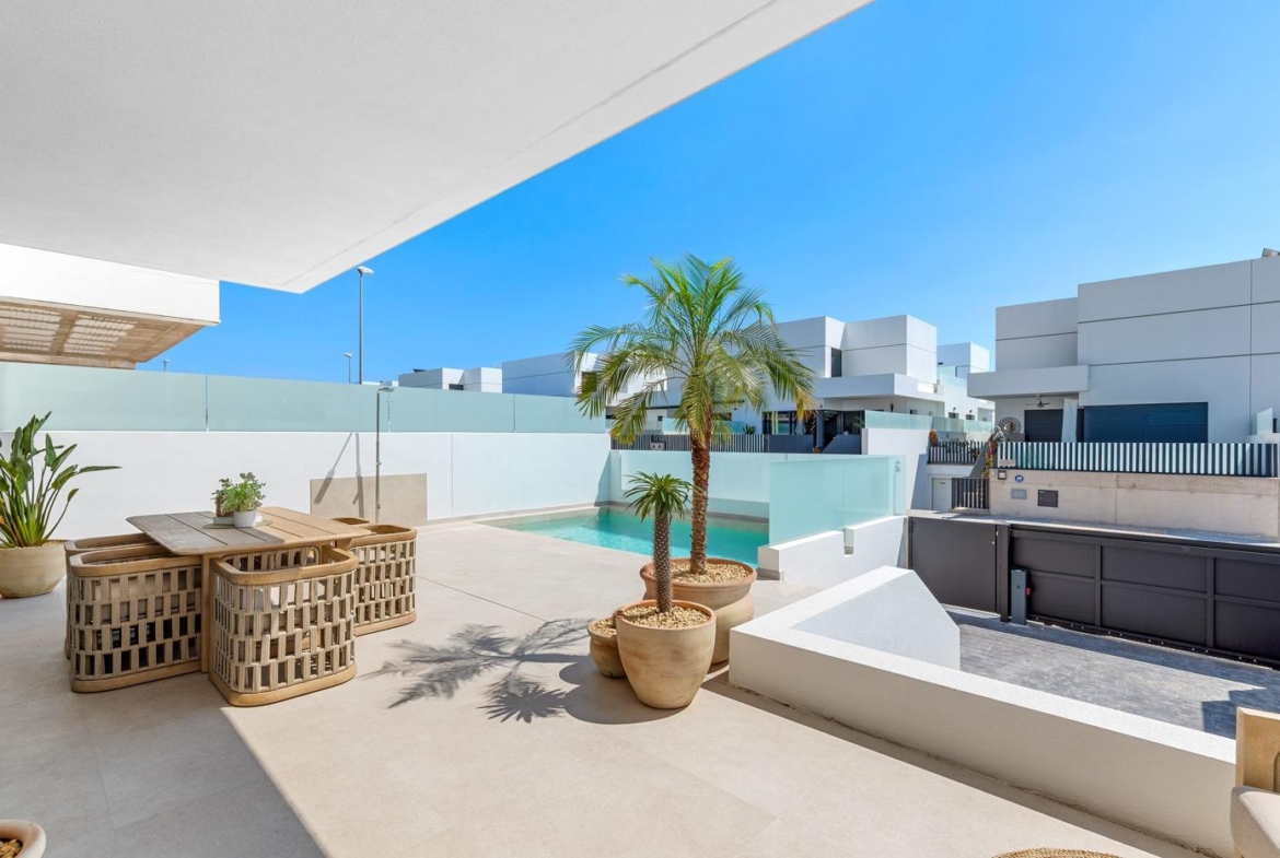 Sun-drenched terrace with stylish outdoor dining and private pool at spacious new build 3-bedroom semi-detached villa in Dolores, Alicante