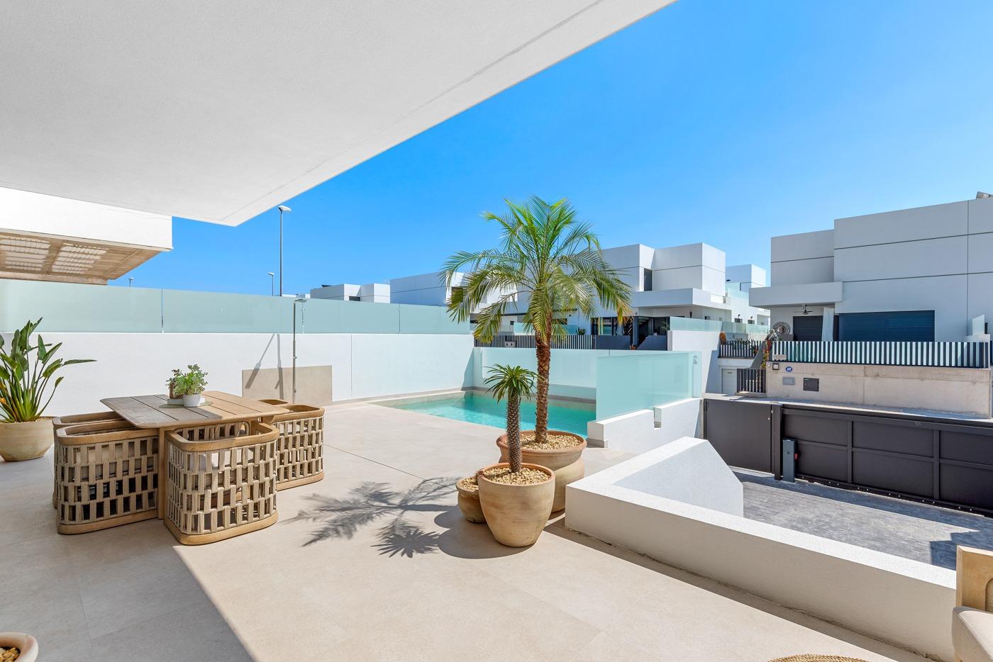 Sun-drenched terrace with stylish outdoor dining and private pool at spacious new build 3-bedroom semi-detached villa in Dolores, Alicante