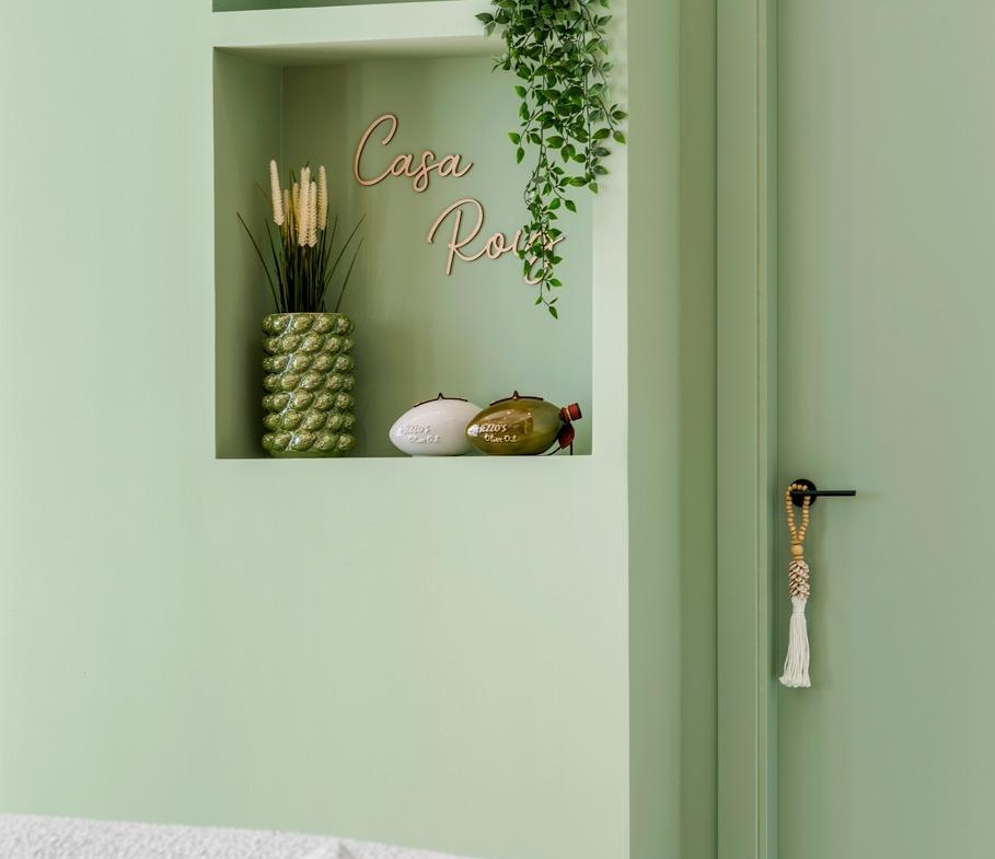 Elegant corner of a spacious new build 3-bedroom semi-detached villa in Dolores, Alicante with soft green walls and cozy textured seating.