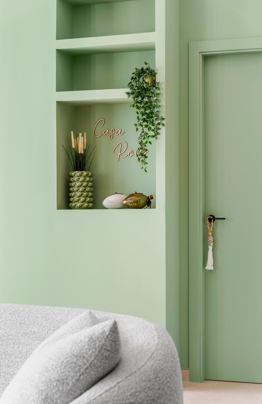 Elegant corner of a spacious new build 3-bedroom semi-detached villa in Dolores, Alicante with soft green walls and cozy textured seating.