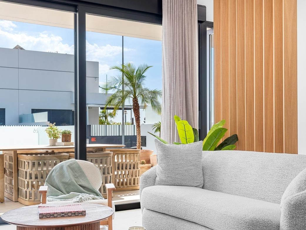 Bright, modern living room with textured sofa and wooden accents in spacious 3-bedroom semi-detached villa in Dolores, Alicante