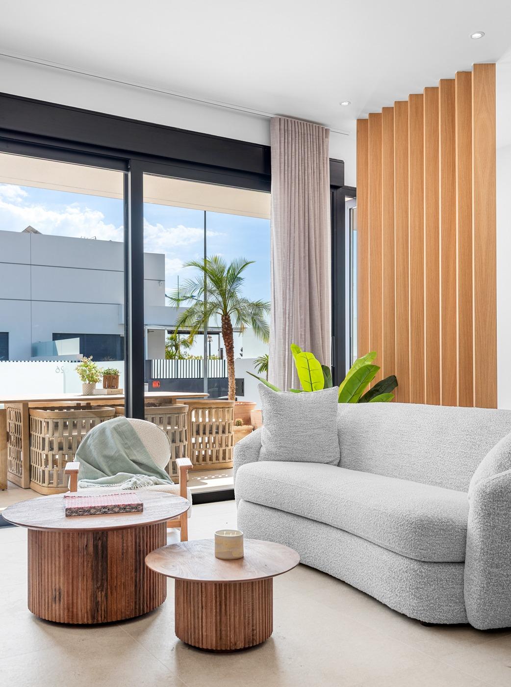 Bright, modern living room with textured sofa and wooden accents in spacious 3-bedroom semi-detached villa in Dolores, Alicante