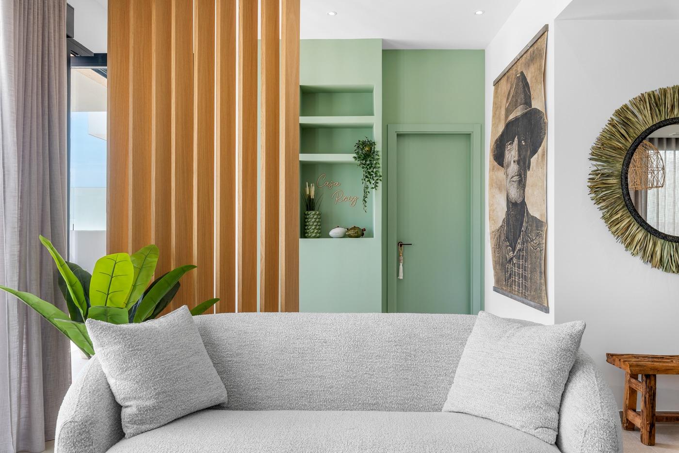 Bright modern living room with elegant light gray sofa and artistic decor in spacious 3 bedroom semi-detached villa in Dolores, Alicante.