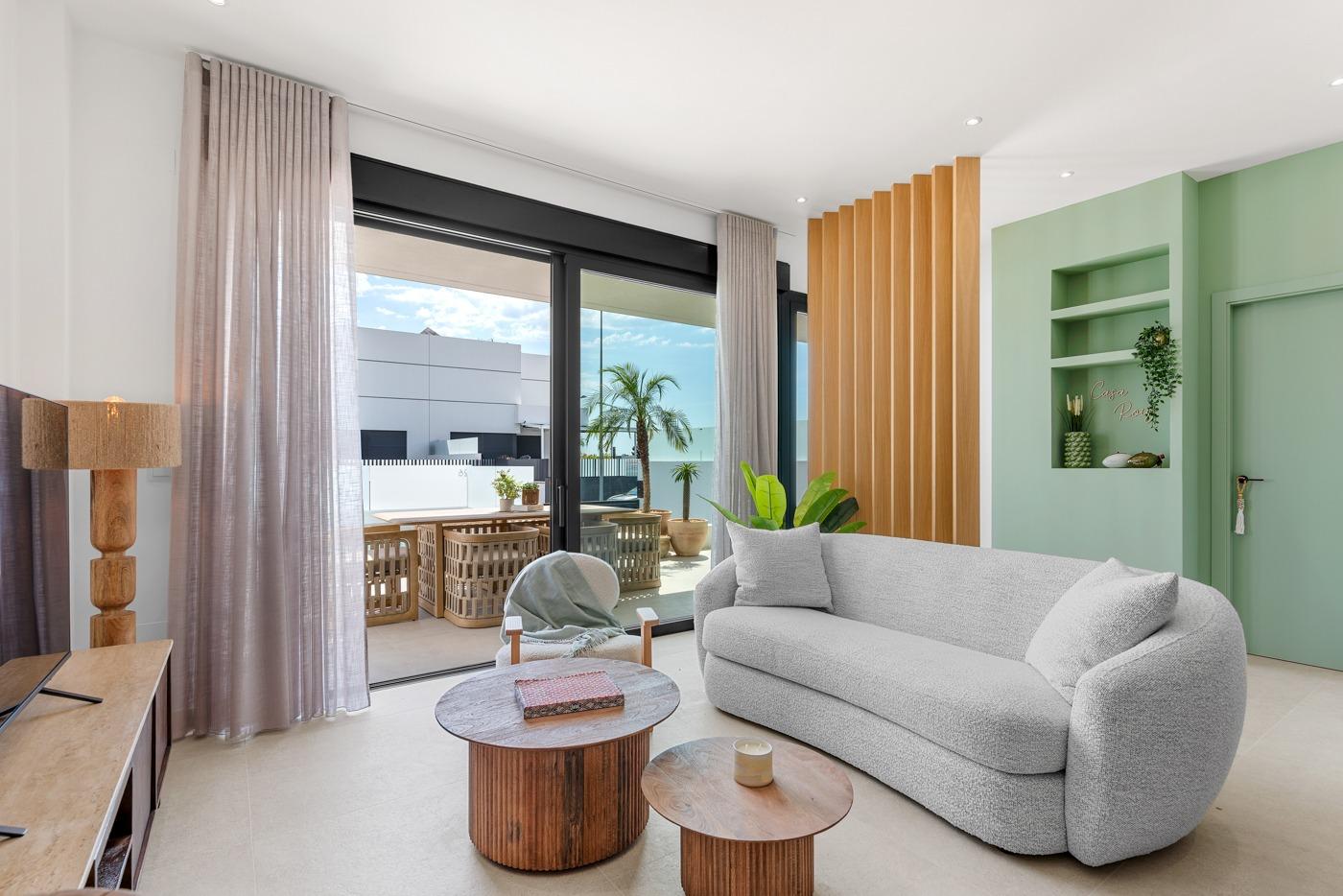Bright, modern living room with stylish furniture and large sliding doors opening to a sunny terrace in Dolores 3-bedroom villa.