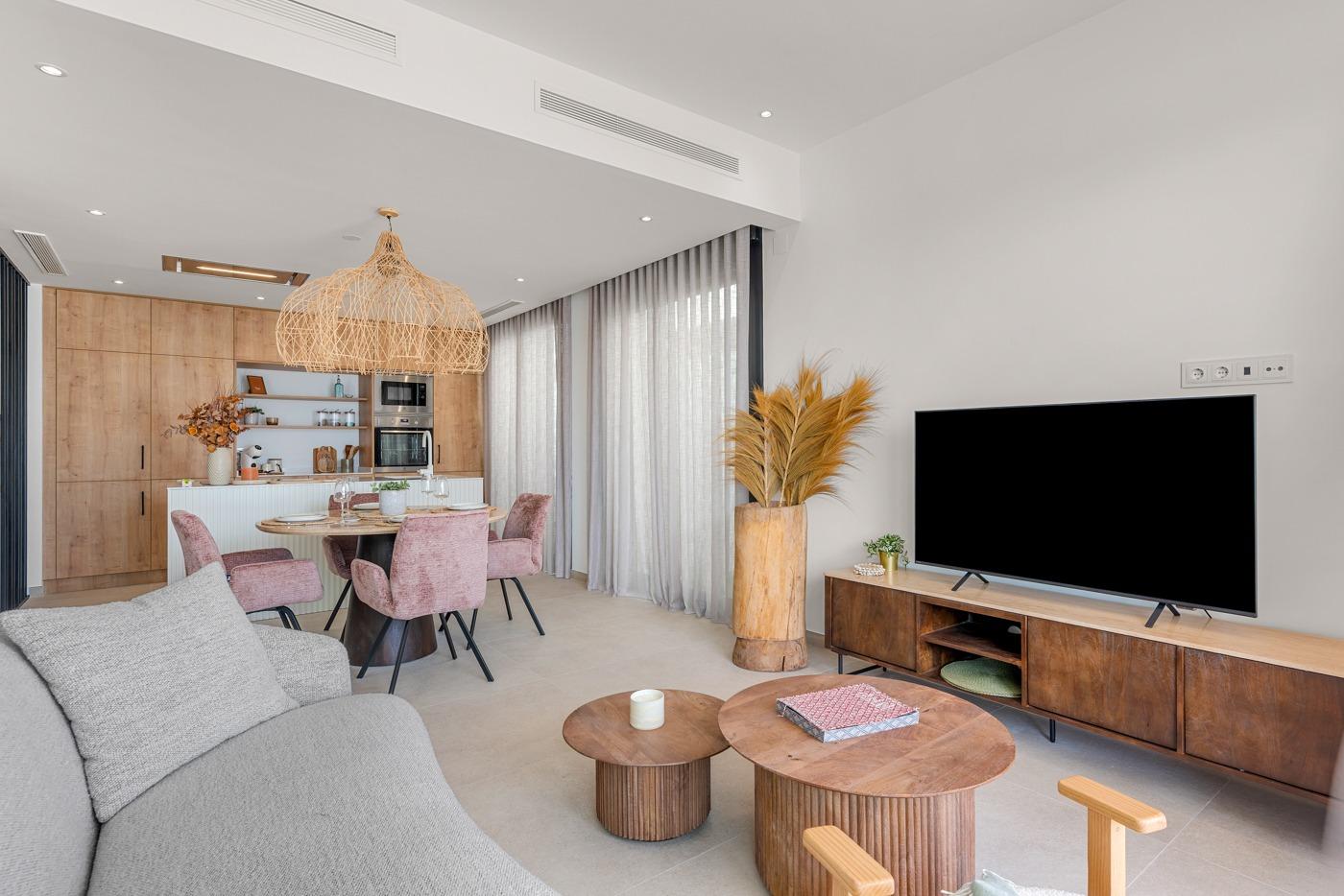 Bright, modern open-plan living and dining area with stylish furnishings in a spacious 3-bedroom villa in Dolores, Alicante.