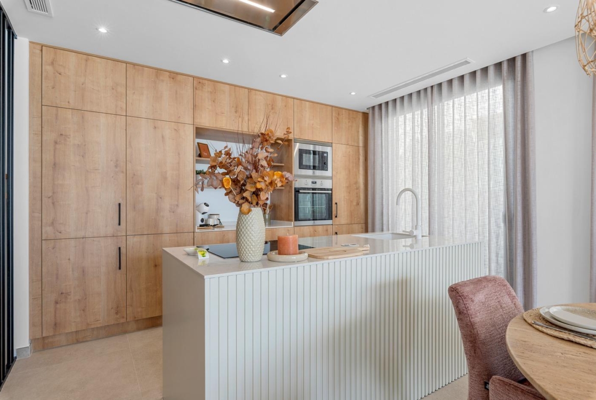 Modern bright kitchen with wood cabinetry and island in spacious new build 3-bedroom villa in Dolores, Alicante