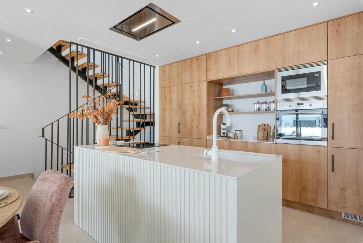 Modern, bright open-plan kitchen with sleek island and wooden cabinetry in spacious 3-bedroom semi-detached villa, Dolores Alicante.
