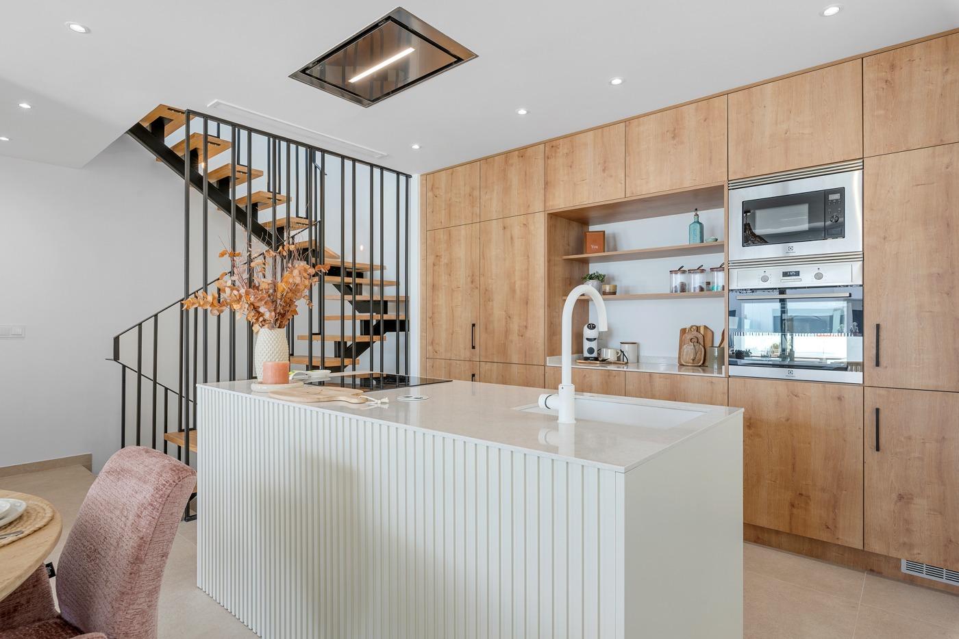 Modern, bright open-plan kitchen with sleek island and wooden cabinetry in spacious 3-bedroom semi-detached villa, Dolores Alicante.