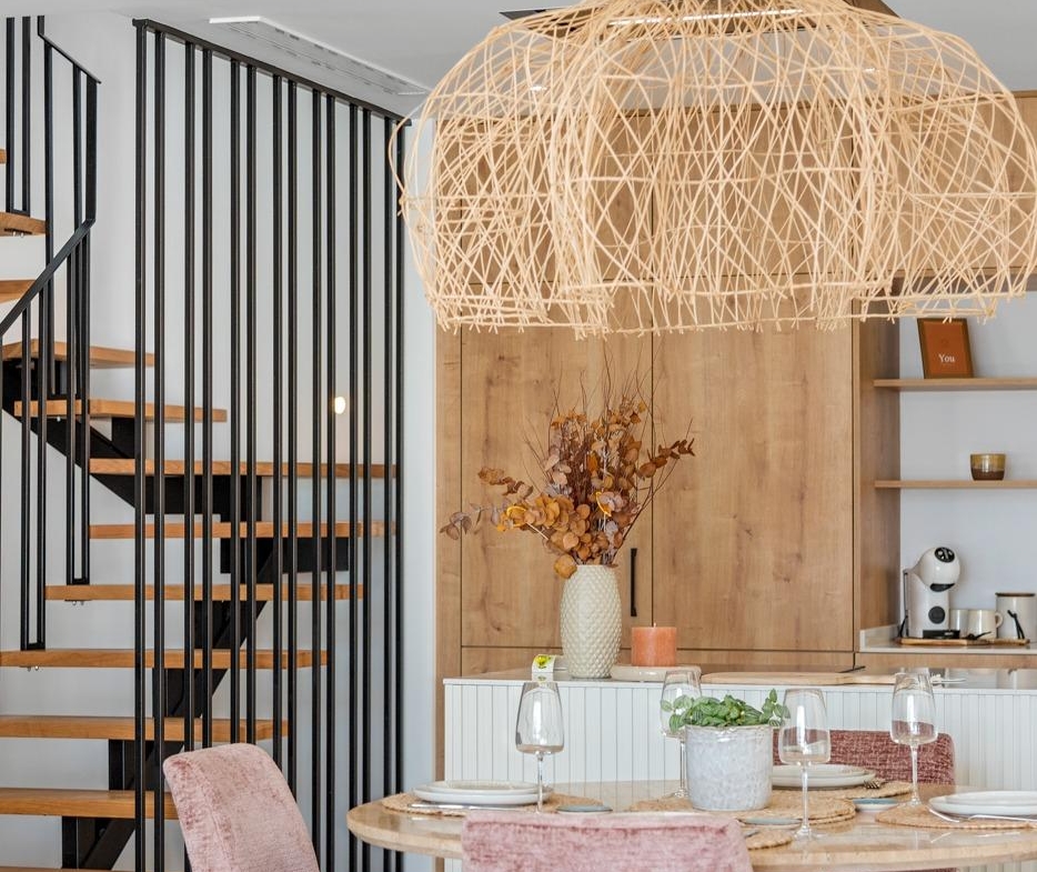 Elegant open-plan dining area with pastel velvet chairs and modern staircase in spacious 3-bedroom villa, Dolores, Alicante.