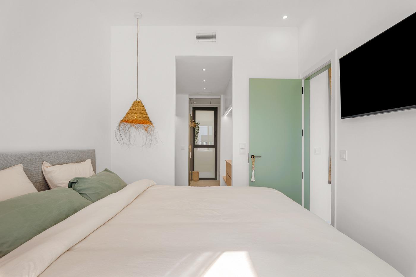 Bright and serene bedroom in a spacious new build 3-bedroom semi-detached villa in Dolores, Alicante with modern decor.