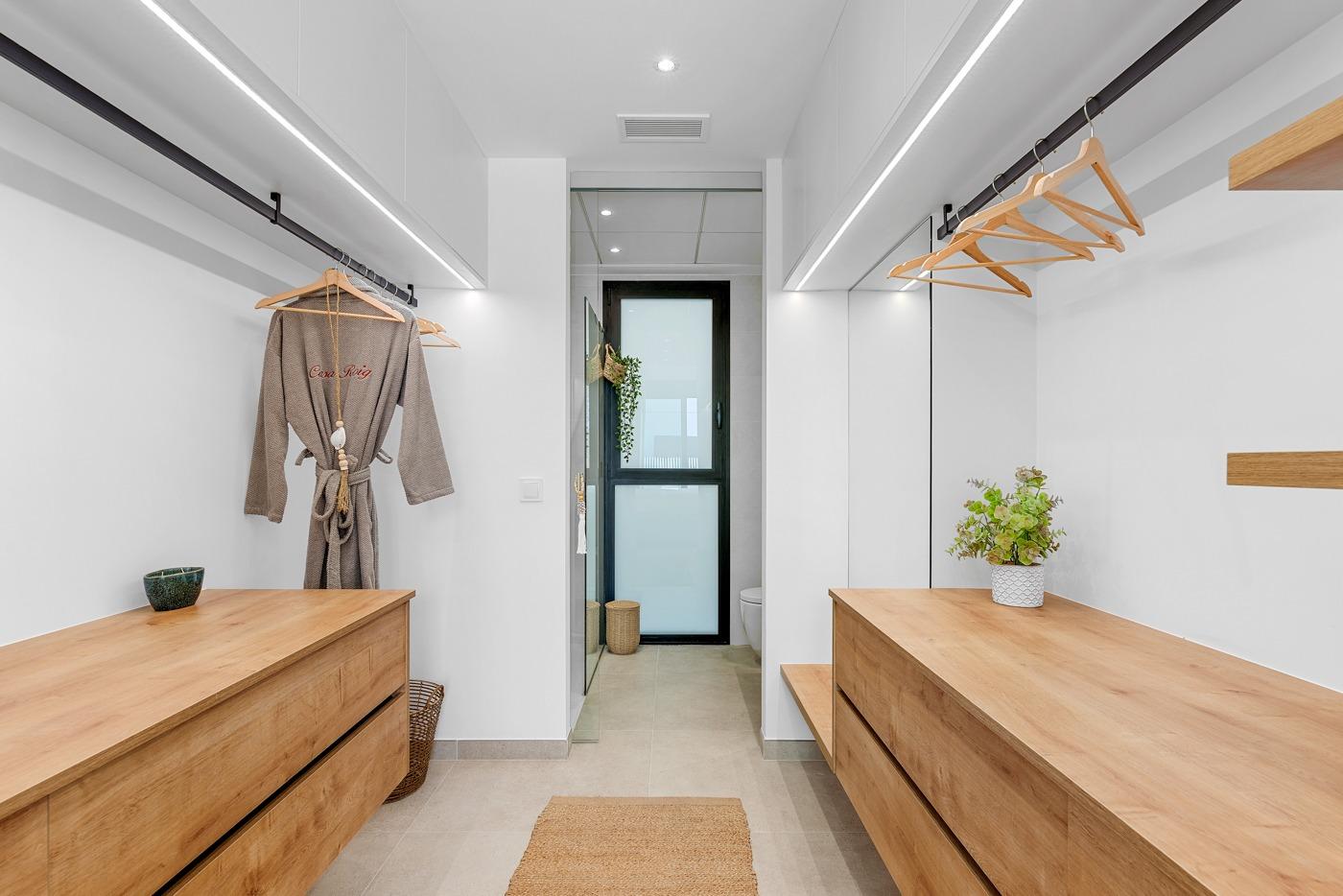 Bright, modern walk-in wardrobe with sleek wooden cabinets in spacious 3-bedroom semi-detached villa in Dolores, Alicante