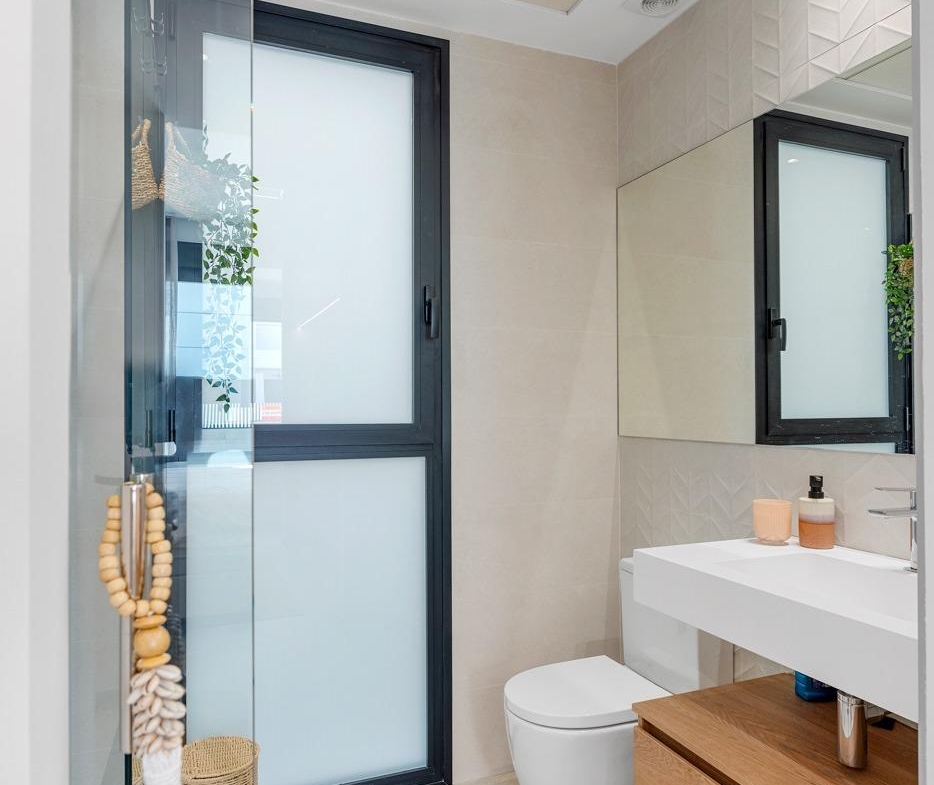 Bright modern bathroom with sleek fixtures and frosted window in spacious new build 3-bedroom villa in Dolores, Alicante
