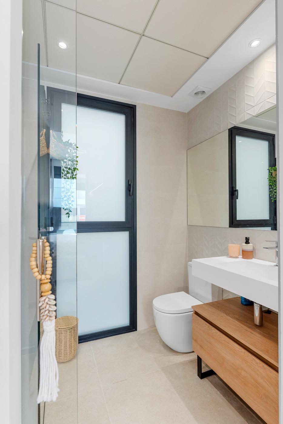 Bright modern bathroom with sleek fixtures and frosted window in spacious new build 3-bedroom villa in Dolores, Alicante