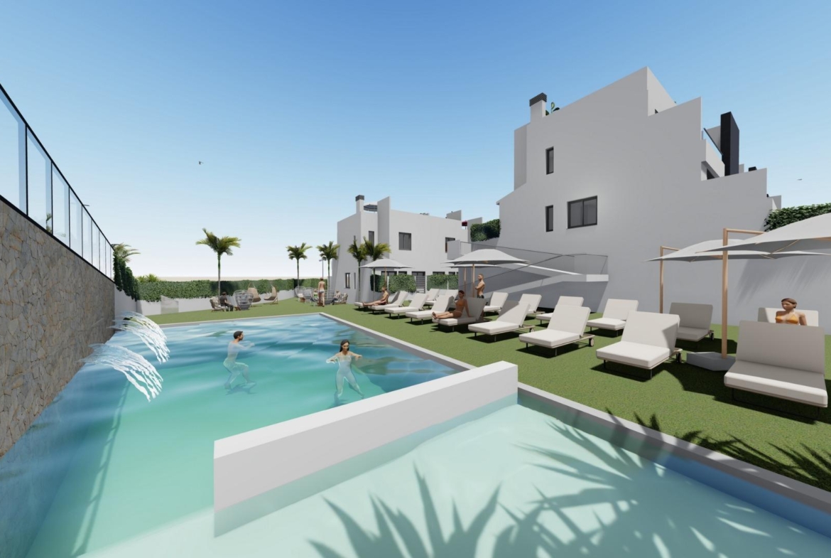 Sun-drenched communal pool with modern sun loungers at affordable new build 2-bedroom townhouse complex in Cox, Alicante.