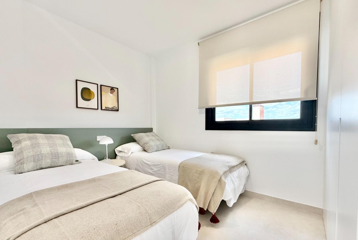 Bright and modern twin bedroom with minimalist decor in a spacious 3-bedroom townhouse in Cox, Alicante.