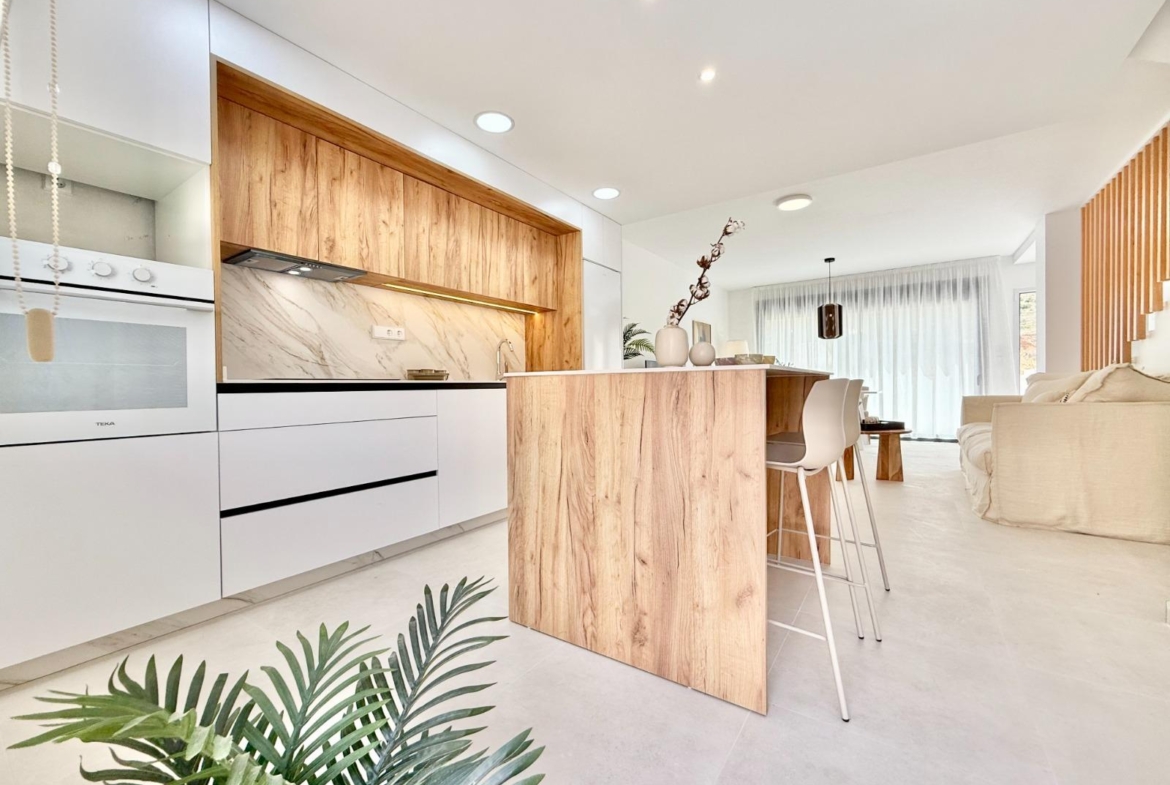 Bright modern kitchen with wood accents and open-plan living in affordable 2-bedroom townhouse in Cox, Alicante.
