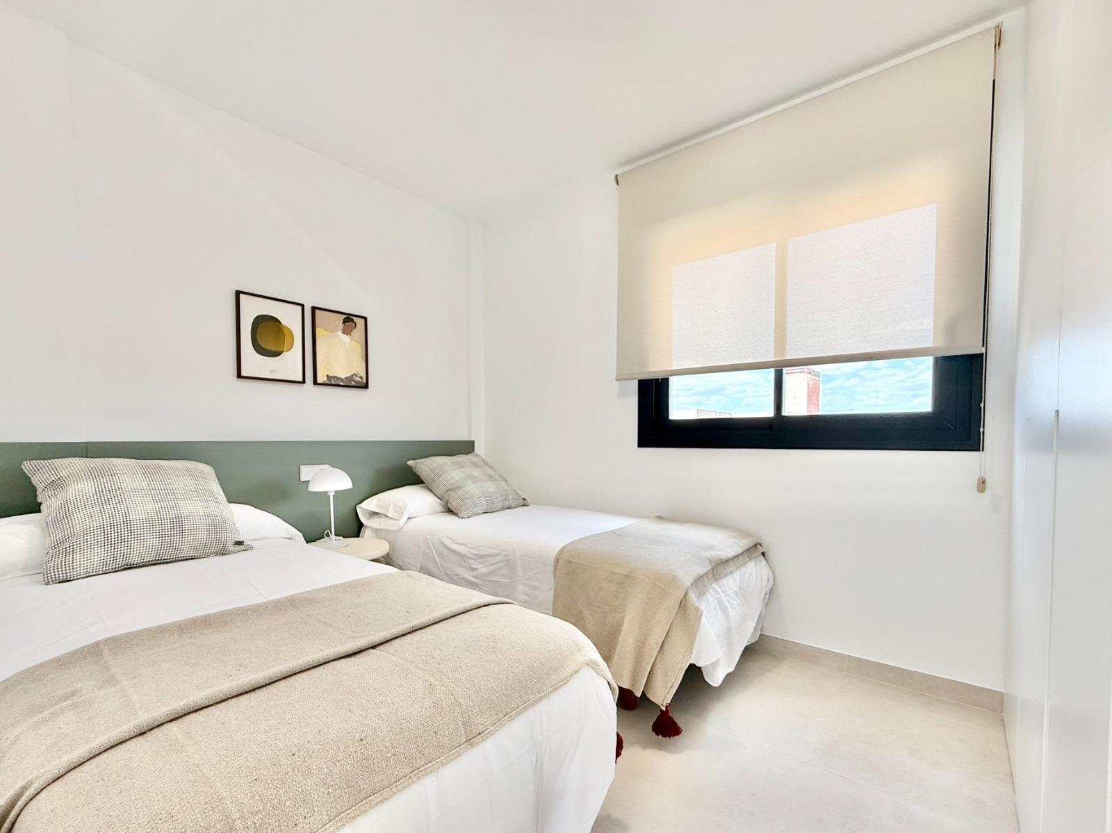 Bright, modern twin bedroom with soft natural light in a new 2-bedroom townhouse in Cox, Alicante