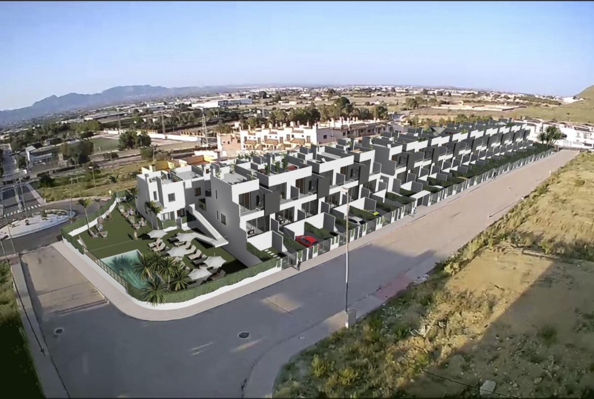 Panoramic aerial view of spacious new build 3-bedroom townhouses with modern design, solariums, and communal pool in Cox, Alicante.