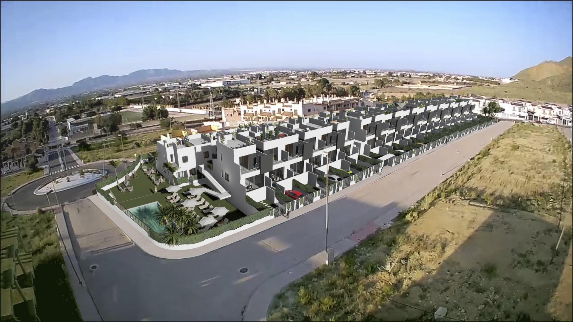 Panoramic aerial view of spacious new build 3-bedroom townhouses with modern design, solariums, and communal pool in Cox, Alicante.