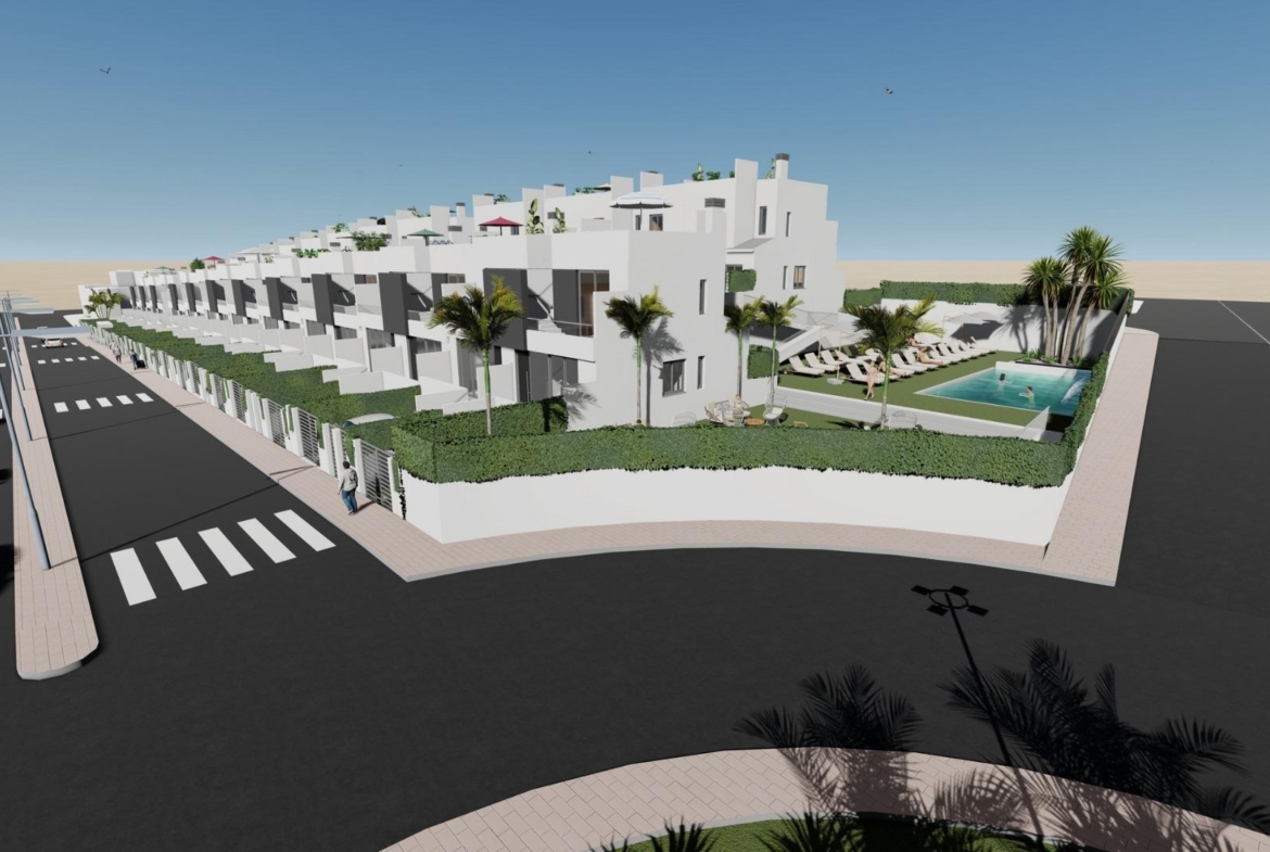Modern white two-bedroom townhouse with solarium and lush communal pool in sunny Cox, Alicante, surrounded by landscaped greenery.
