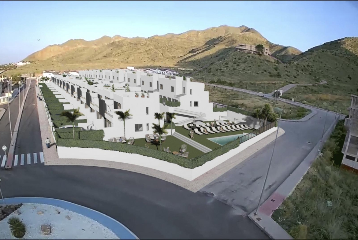 Bright modern new build 2-bedroom townhouses with landscaped gardens and communal pool, set against sunlit hills in Cox, Alicante.