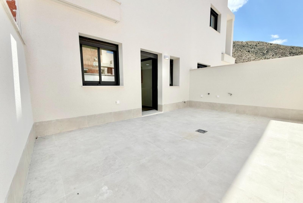 Spacious sunlit terrace of affordable new build 2 bedroom townhouse in Cox, Alicante with sleek modern finishes and mountain views.