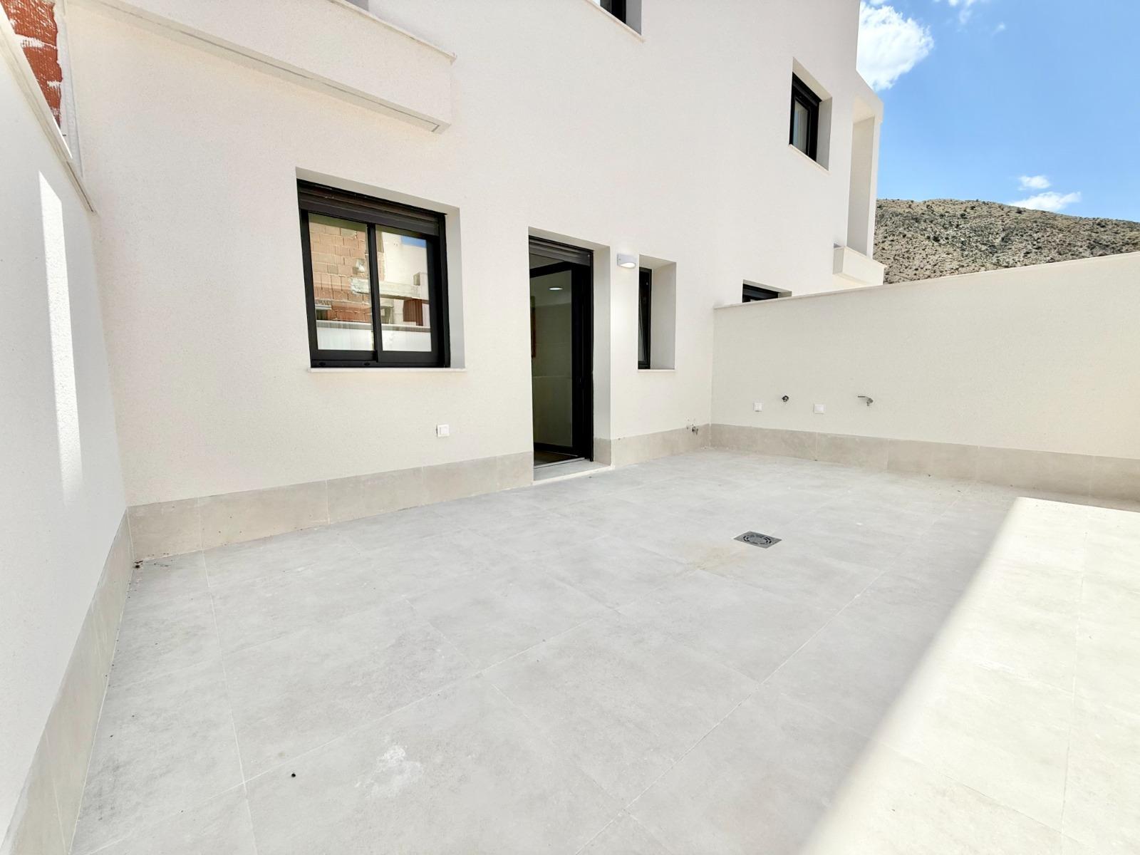 Spacious sunlit terrace of affordable new build 2 bedroom townhouse in Cox, Alicante with sleek modern finishes and mountain views.