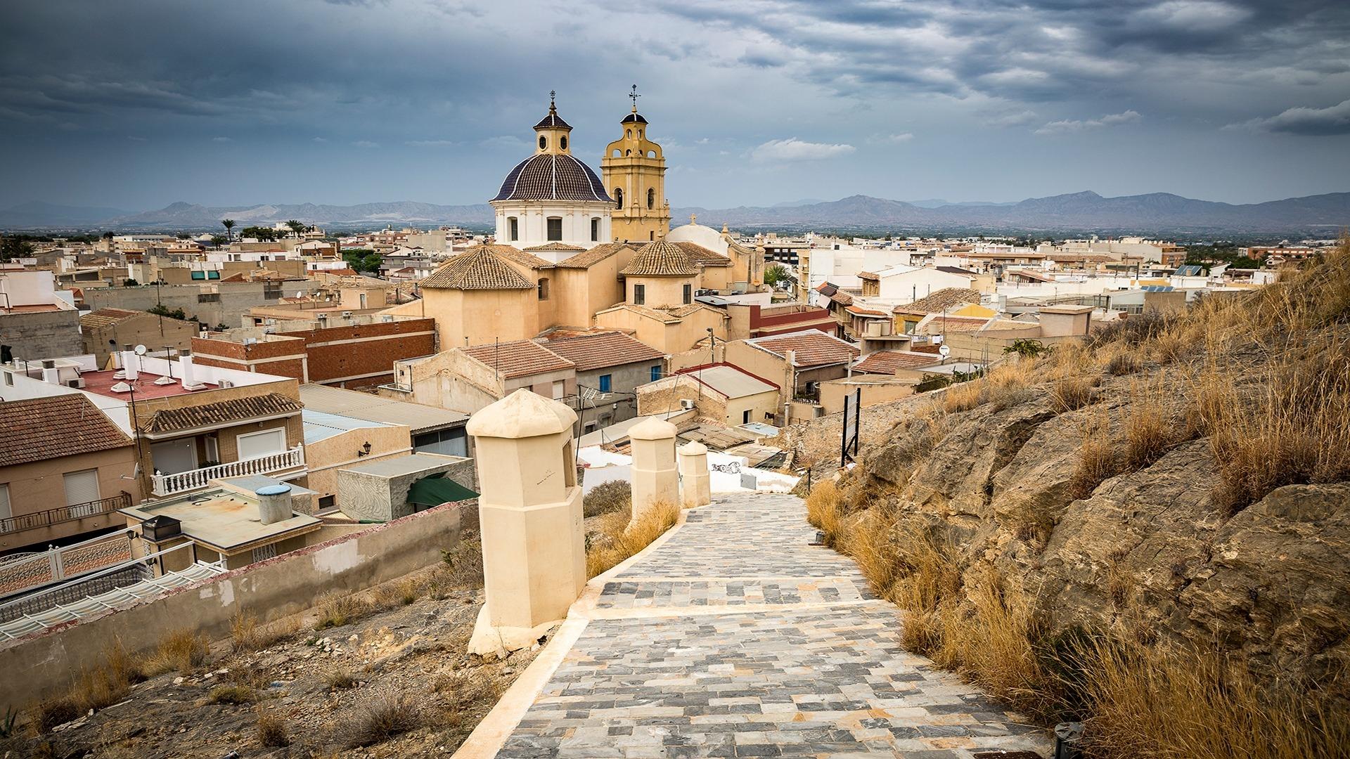 Panoramic view of charming Cox town with historic church and traditional rooftops near new build 2 bedroom townhouse in Alicante.