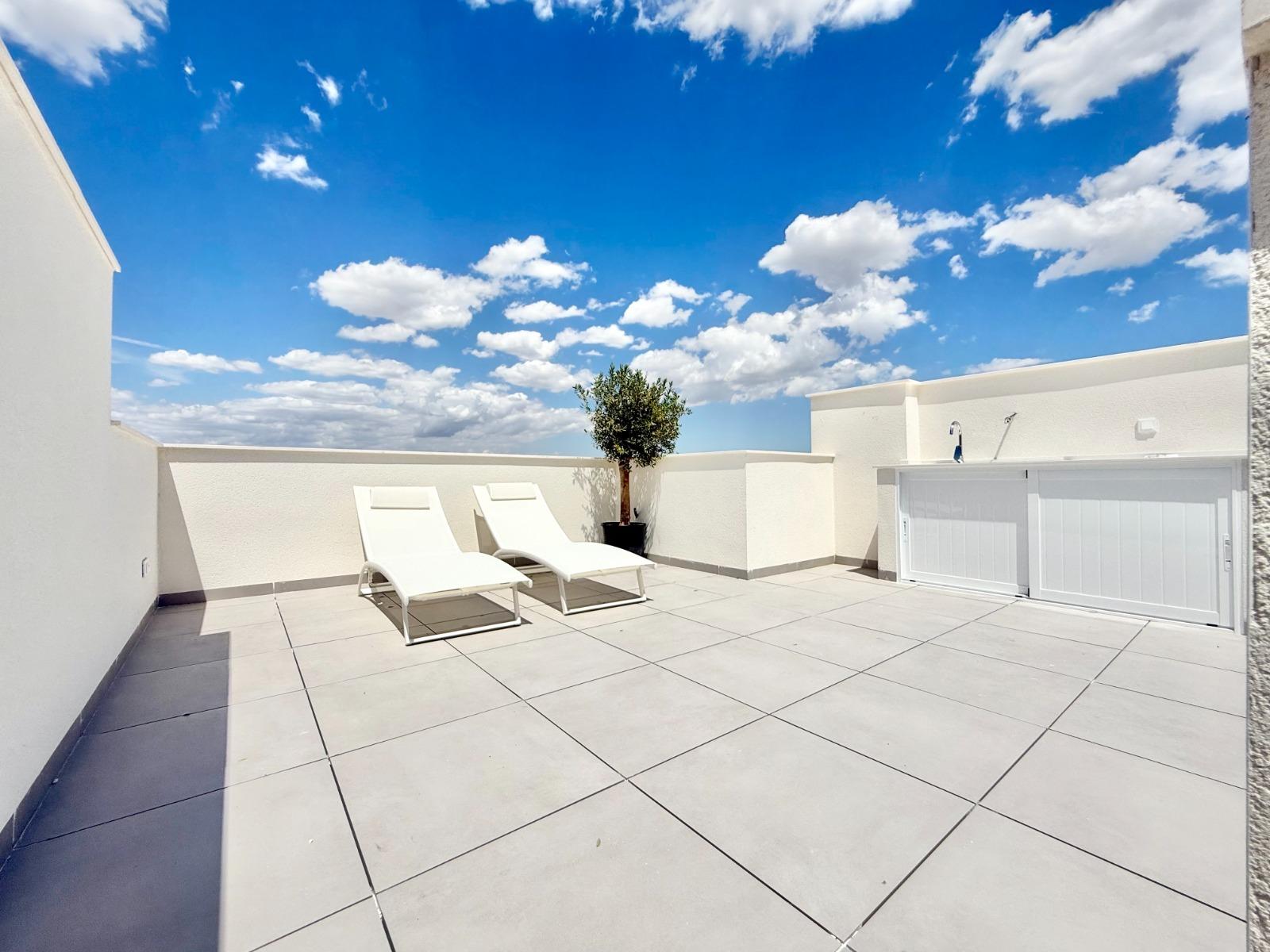 Bright, spacious sun-drenched solarium with loungers at a new build 2-bedroom townhouse in Cox, Alicante.