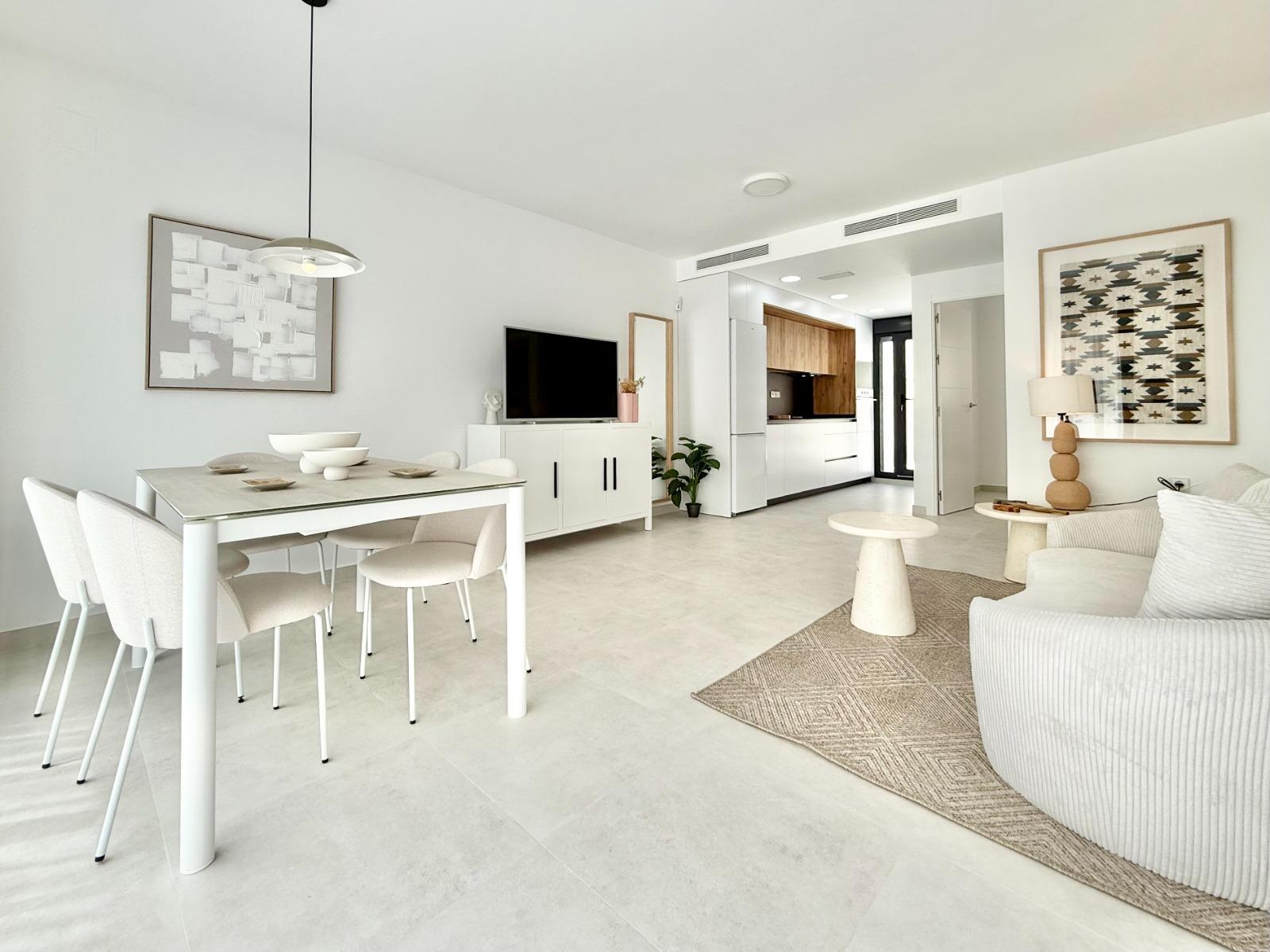 Bright, modern open-plan living and dining area in spacious 3-bedroom townhouse in Cox, Alicante with sleek kitchen and elegant decor.