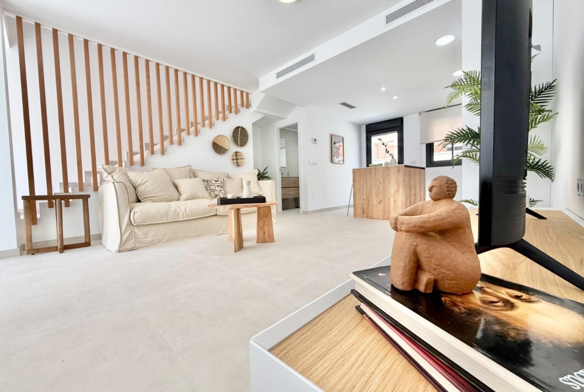 Bright modern living room with elegant wooden accents in affordable 2-bedroom Cox townhouse, Alicante new build.