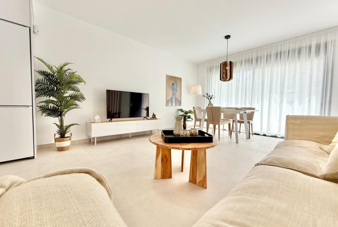 Bright modern living and dining area with minimalist design in affordable 2-bedroom townhouse in Cox, Alicante.