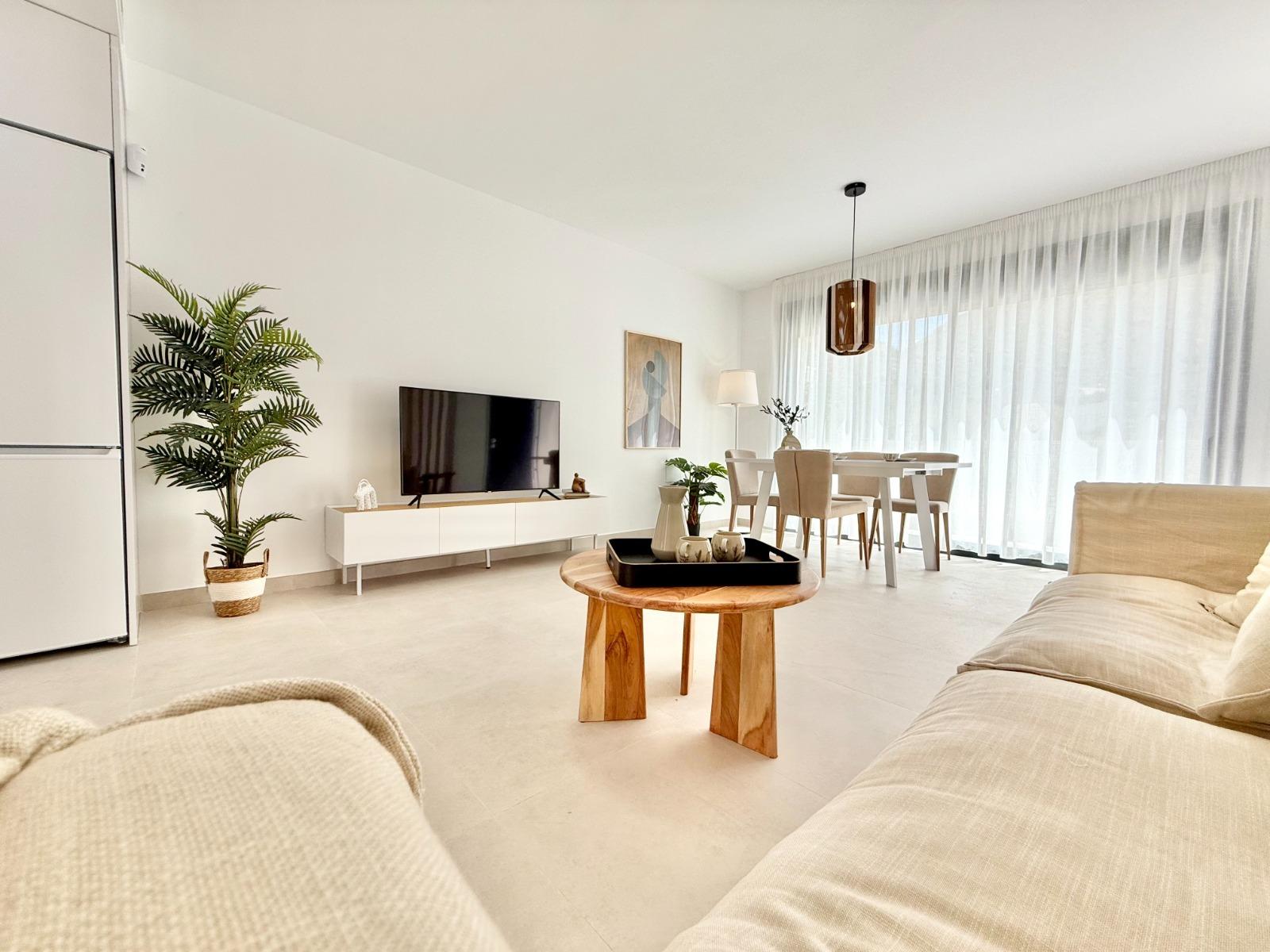 Bright modern living and dining area with minimalist design in affordable 2-bedroom townhouse in Cox, Alicante.