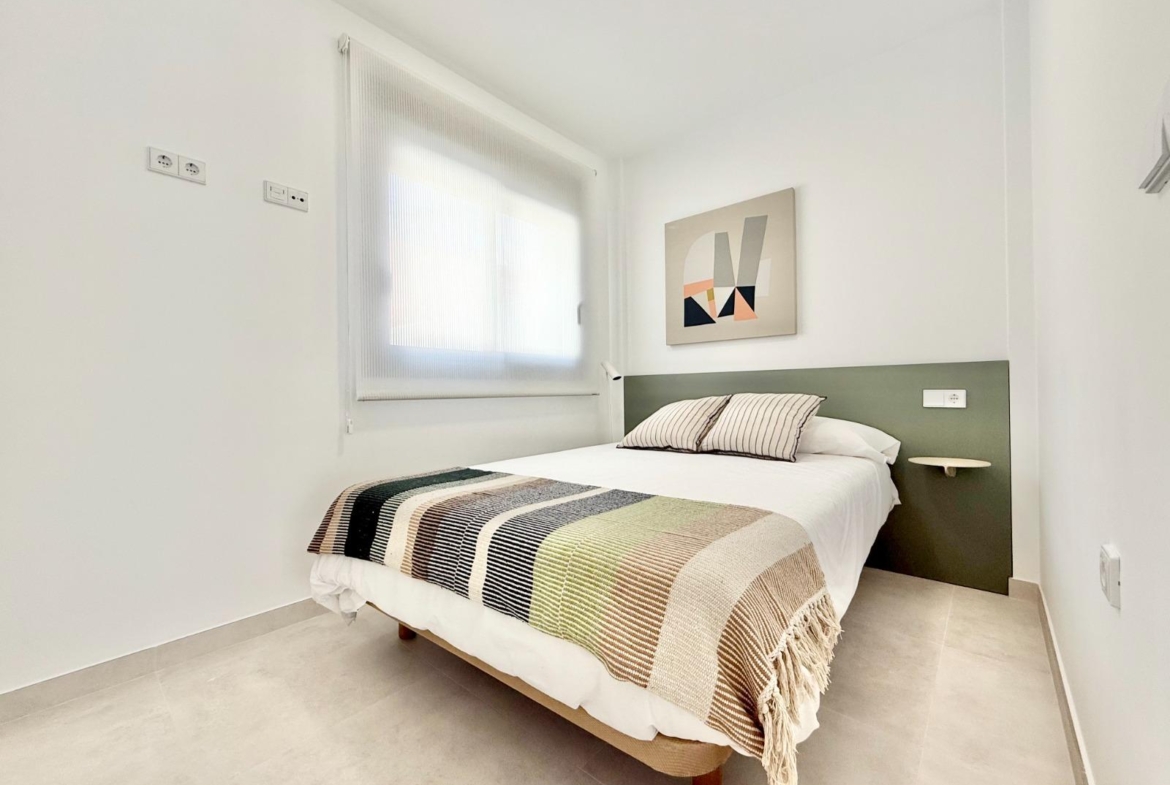Bright and modern bedroom in a spacious 3-bedroom townhouse with minimalist design in Cox, Alicante.