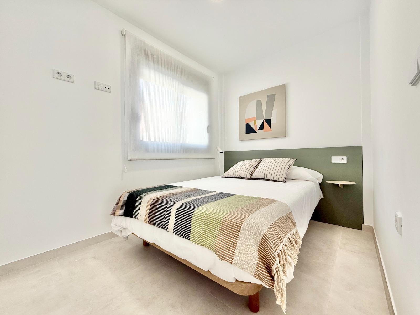 Bright and modern bedroom in a spacious 3-bedroom townhouse with minimalist design in Cox, Alicante.