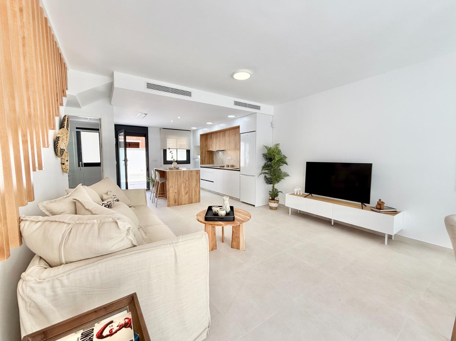 Bright and modern open-plan living area with stylish kitchen in affordable 2-bedroom townhouse in Cox, Alicante.