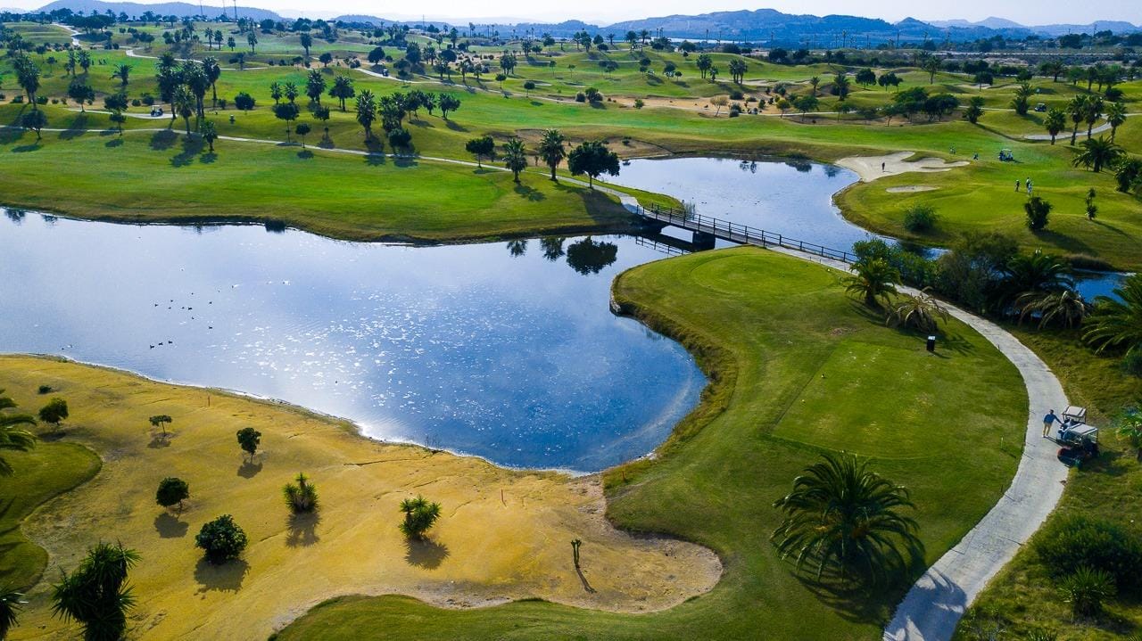 New-Build-Villas-at-Vistabella-Golf-Resort-–-Orihuela-10 Panoramic sun-drenched golf course and sparkling water feature at Vistabella Golf, Orihuela, near luxury villa development.