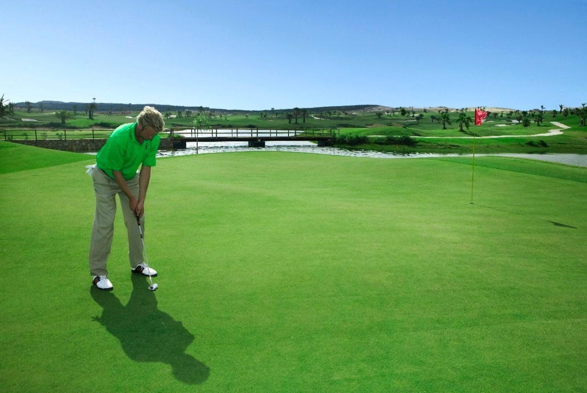 Sunlit, expansive golf course with manicured greens and water features near Vistabella Golf, Orihuela luxury family villa.