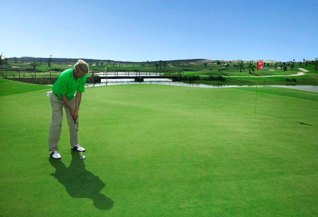New-Build-Villas-at-Vistabella-Golf-Resort-–-Orihuela-4 Sunlit, expansive golf course with manicured greens and water features near Vistabella Golf, Orihuela luxury family villa.
