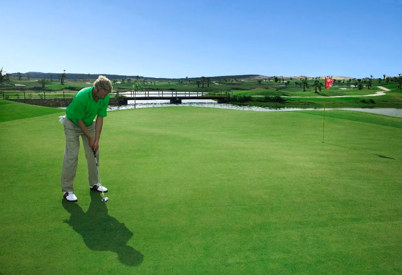 Sunlit, expansive golf course with manicured greens and water features near Vistabella Golf, Orihuela luxury family villa.