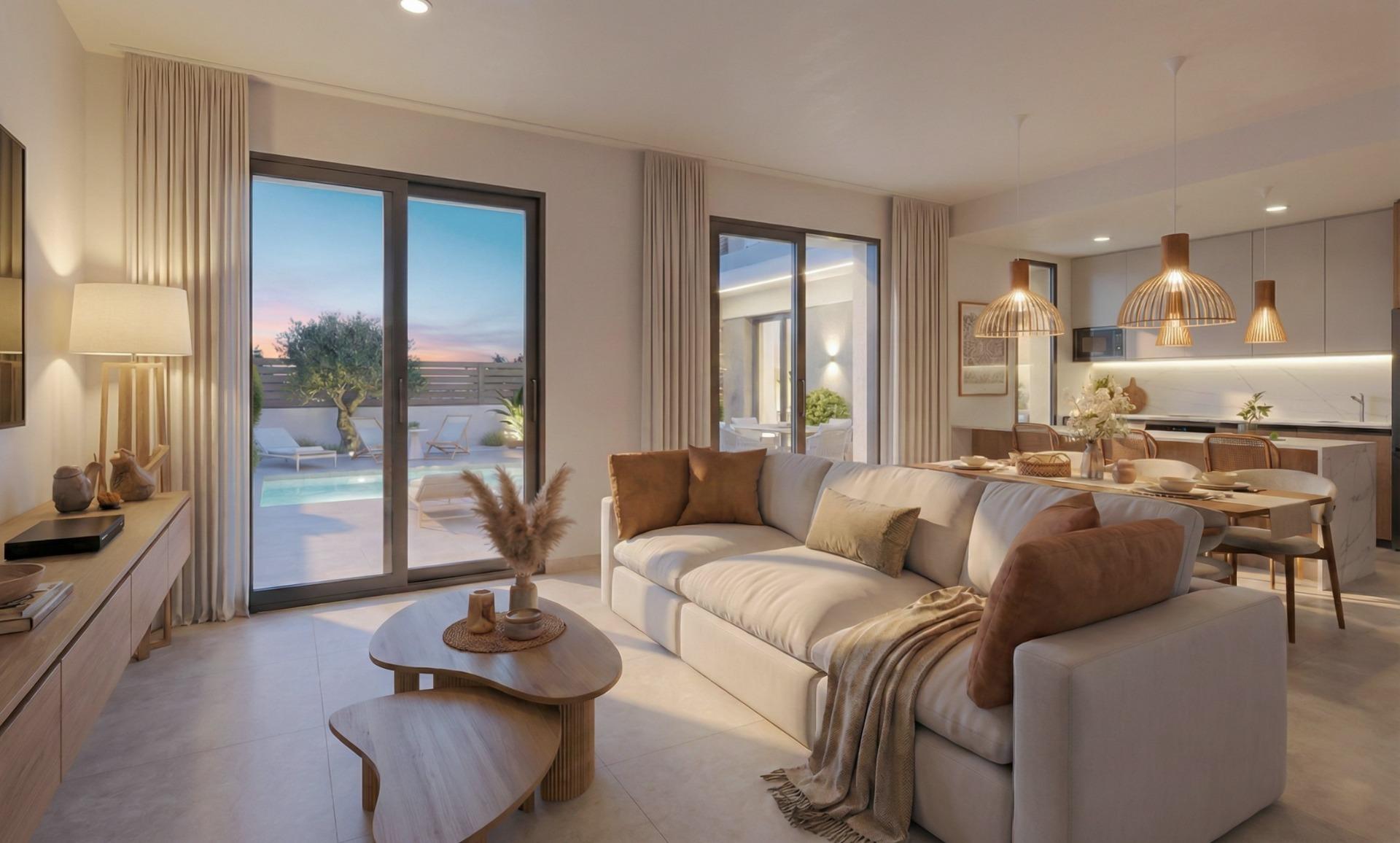 Elegant open-plan living room with soft lighting, stylish kitchen, and pool terrace in luxury single-storey villa, Hacienda del Álamo Murcia.