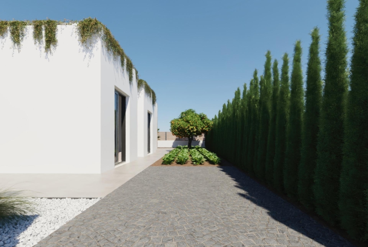 Modern single-storey villa exterior at Hacienda del Álamo with lush greenery, manicured garden, and clear blue sky in Murcia