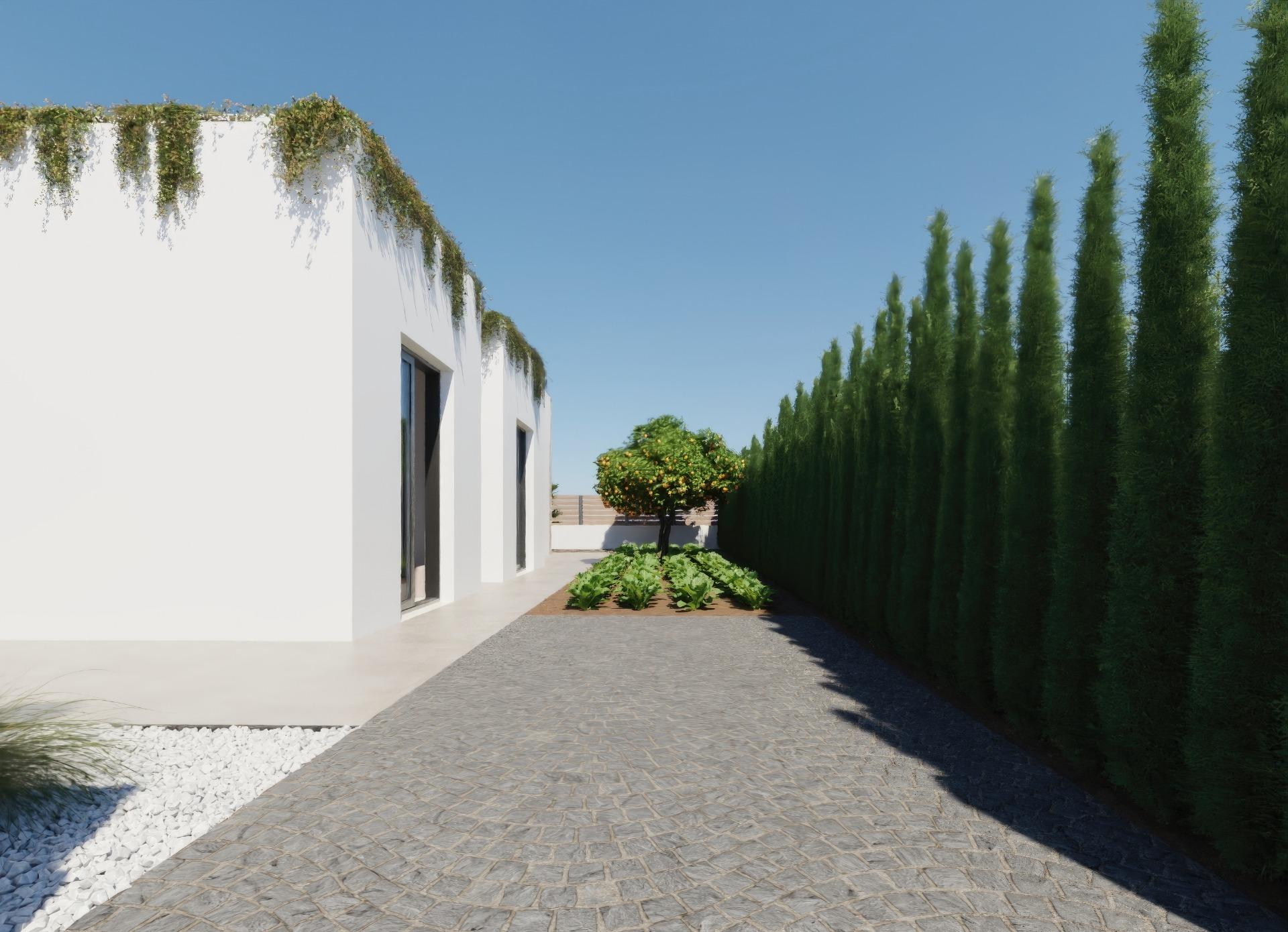 Modern single-storey villa exterior at Hacienda del Álamo with lush greenery, manicured garden, and clear blue sky in Murcia