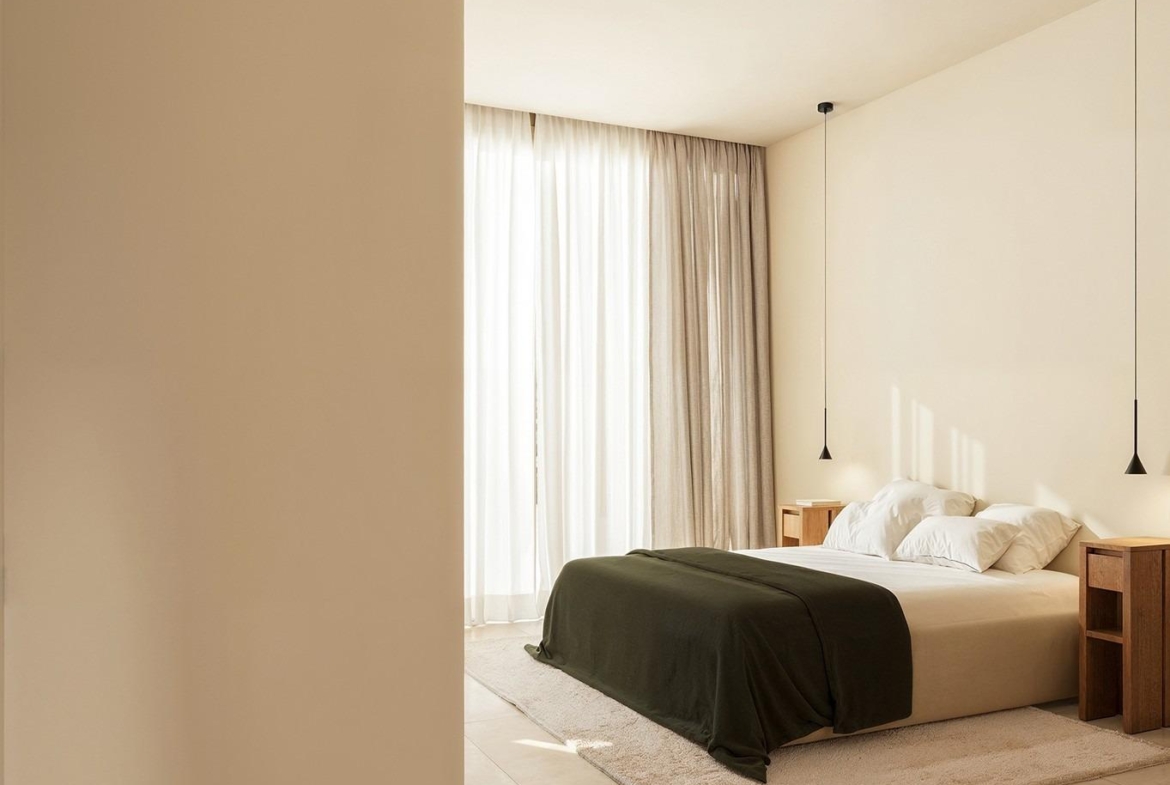 Sun-drenched minimalist bedroom with elegant neutral tones in exclusive Ibiza style villa on La Finca Golf, Algorfa, Costa Blanca.